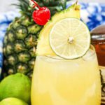 Fill a glass with ice cubes. Pour in 1 shot of spiced rum. Add 1tsp cream of coconut. Pour in 1.5oz of pineapple juice and then 1.5oz of orange juice. Stir with a straw. Garnish with limes, pineapple slices and cherries.